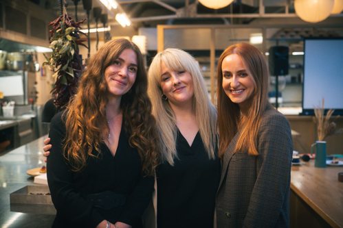 Picture of 3 women.  Woman on the left has long brown hair, woman in the middle has long blond hair and the woman on the right has long auburn hair.